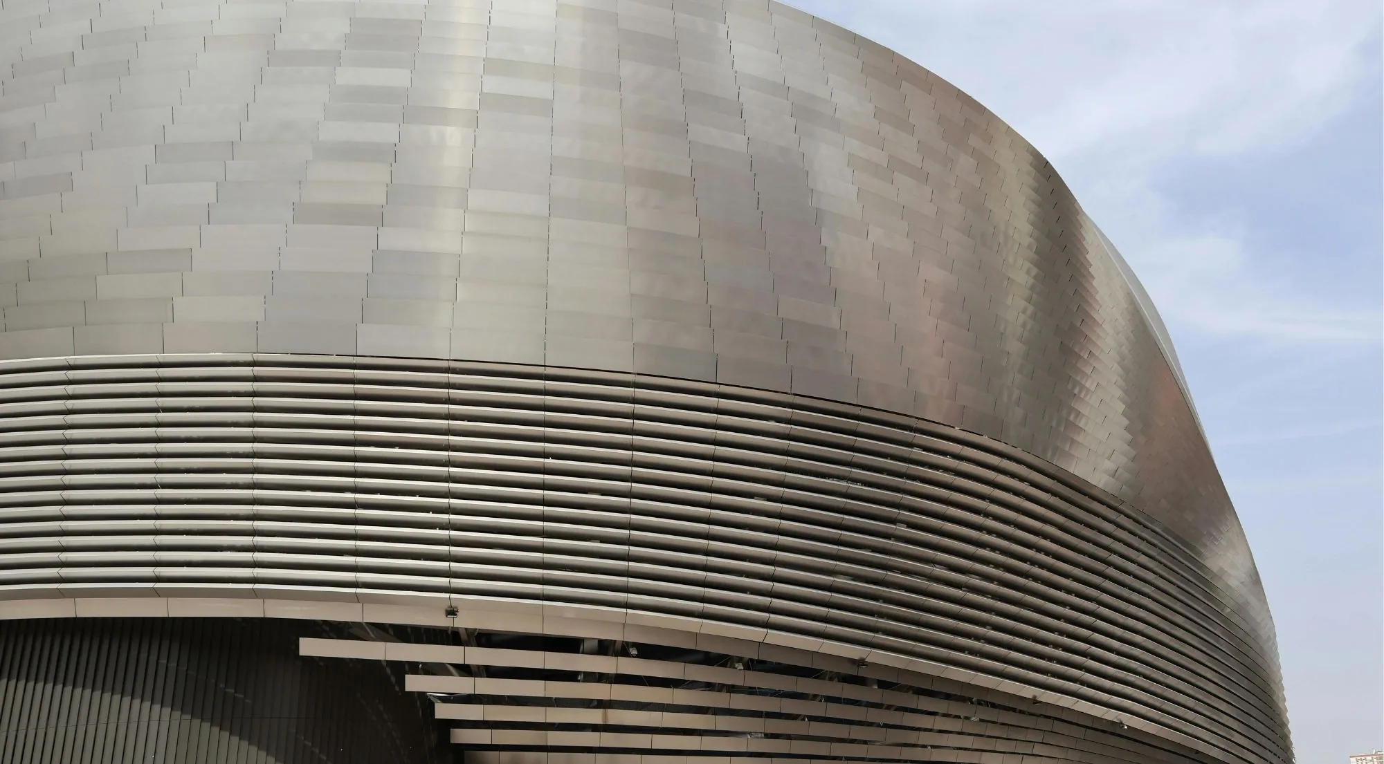 Curved stainless-steel facade of the renovated Santiago Bernabéu stadium