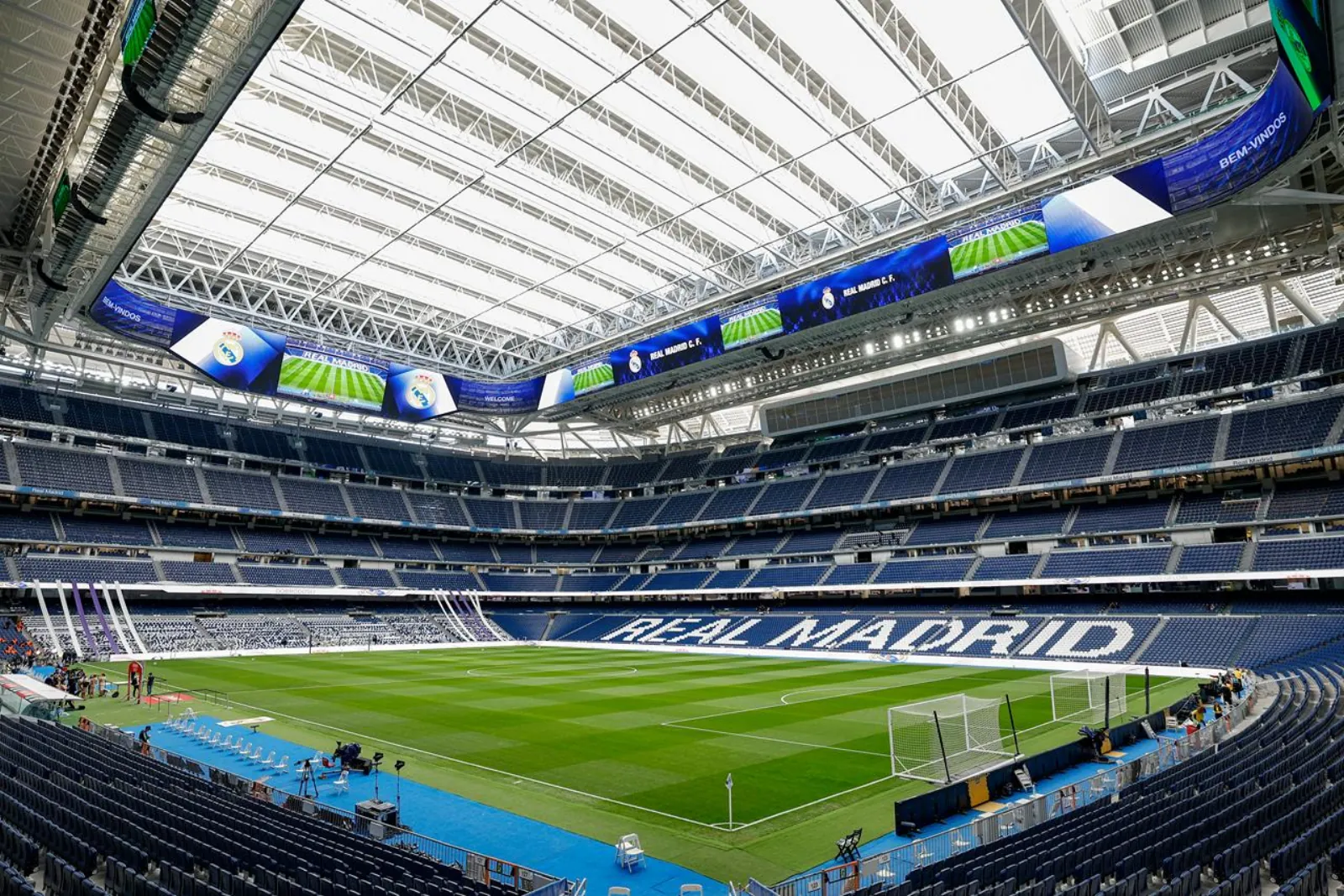 Inside the Bernabéu bowl with the retractable roof above the pitch
