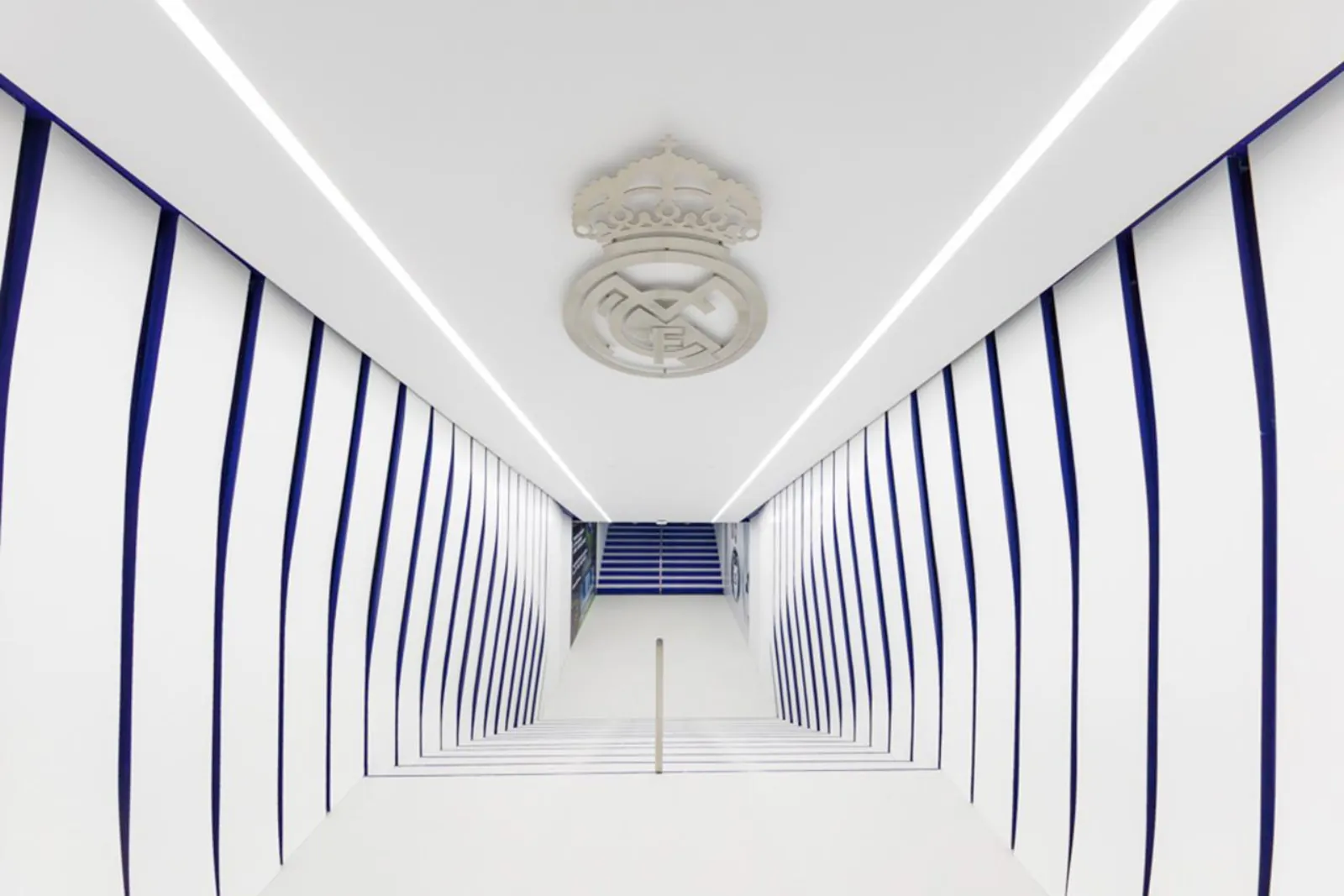 White Real Madrid crest tunnel leading out towards the stands on the Tour Bernabéu