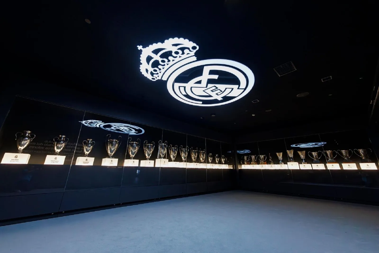 Darkened trophy hall with the illuminated Real Madrid crest