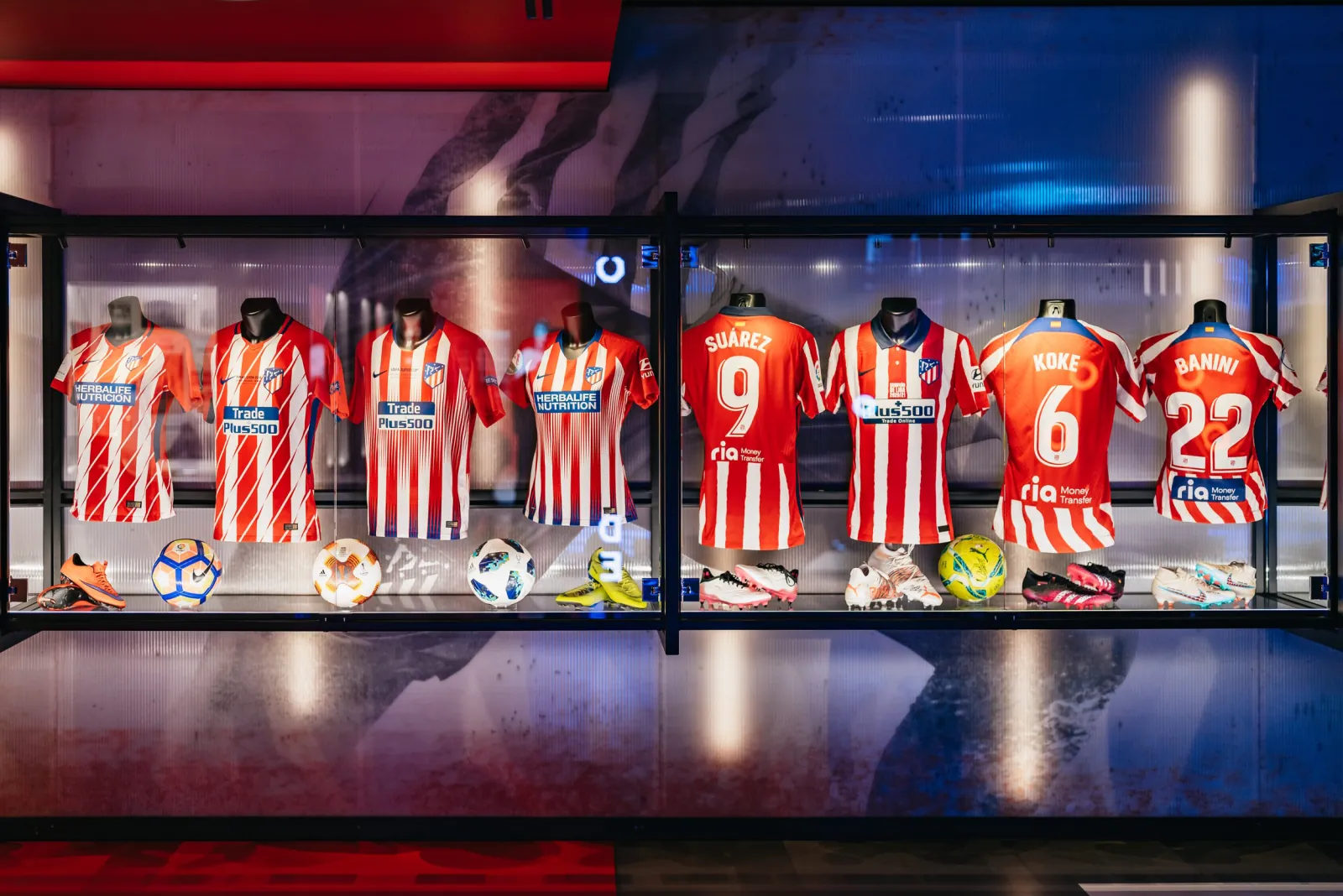 Atlético de Madrid shirts displayed in a museum cabinet