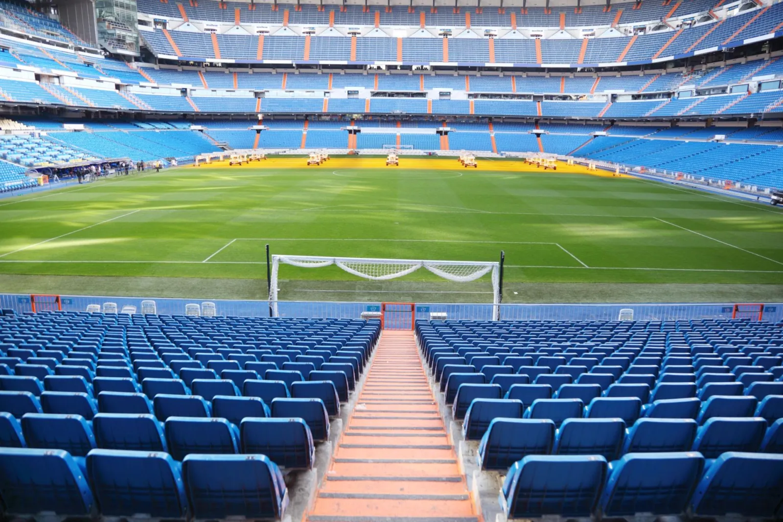 Aisle through blue seats down to the goal at the Bernabéu