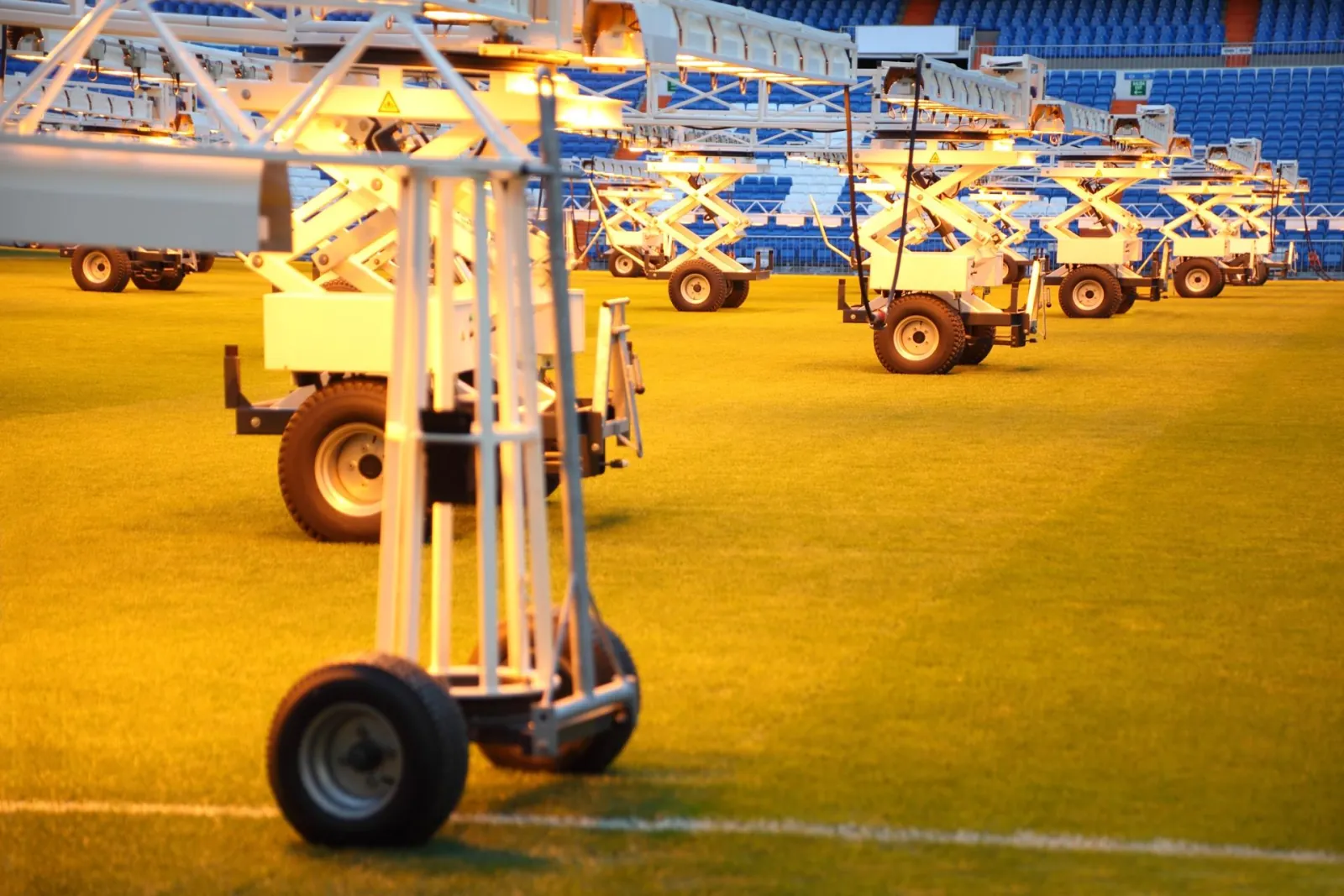 Grow-light rigs on the Bernabéu grass between matches
