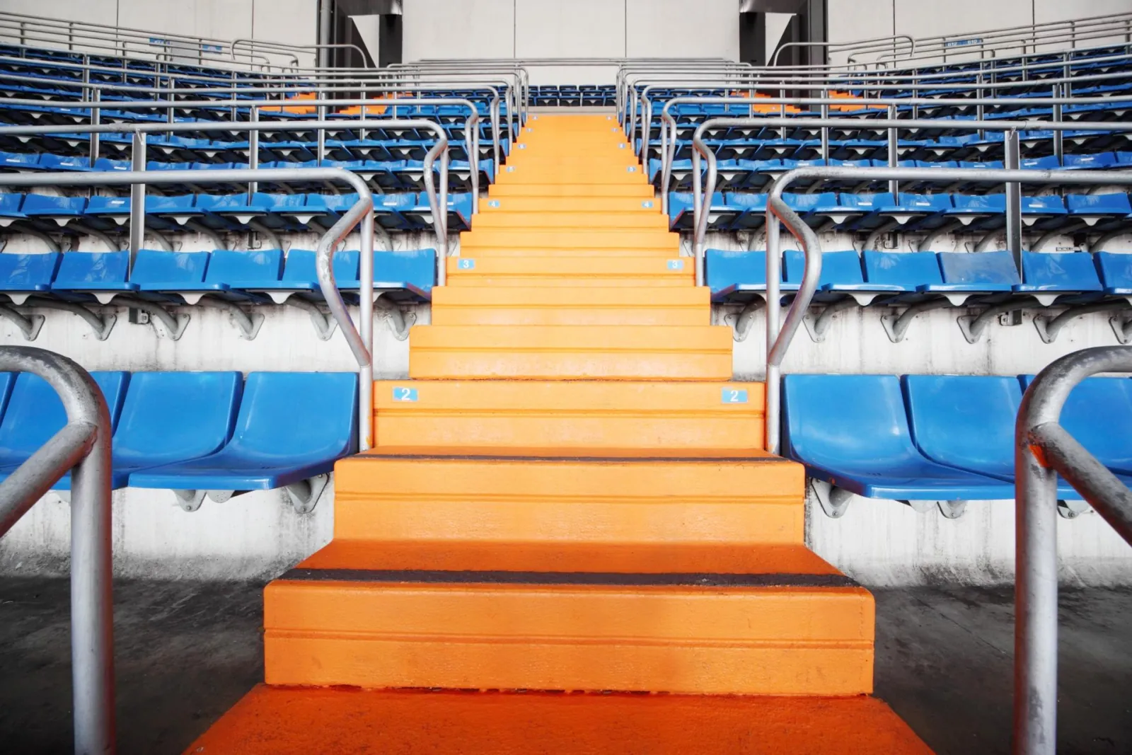 Orange stairway between blue seat rows in the Bernabéu stands