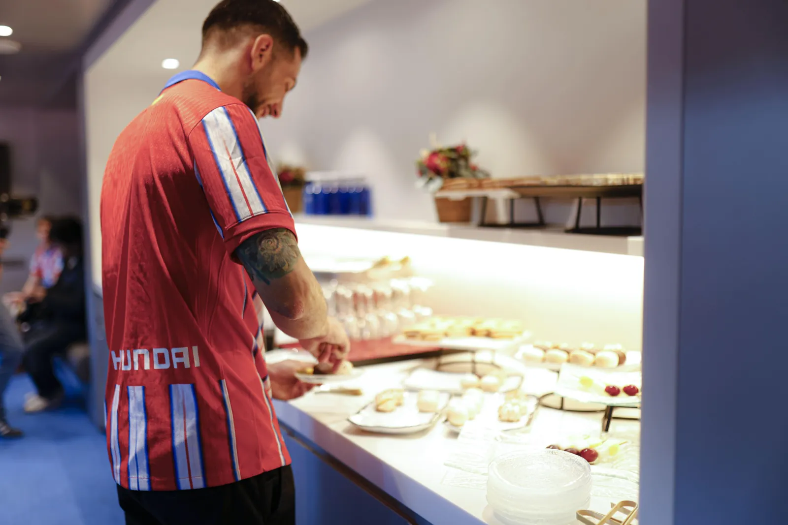 Guest serving breakfast at the buffet in a private stadium box