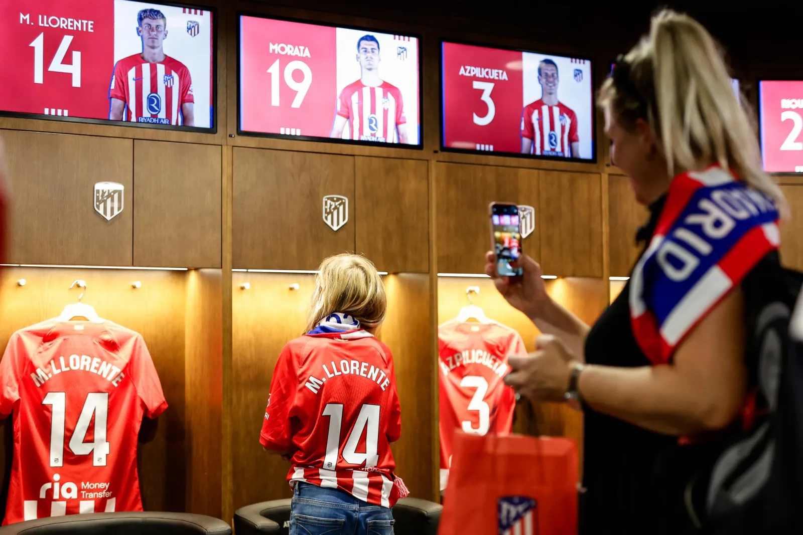 Visitors photographing named shirts in the Atlético first-team dressing room