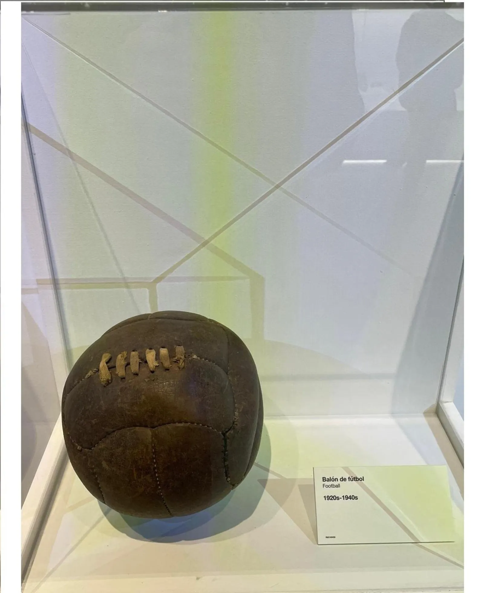 Old leather match ball in a museum display case